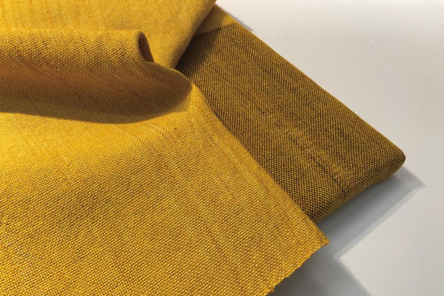 close up image of a yellow fabric folded in on itself