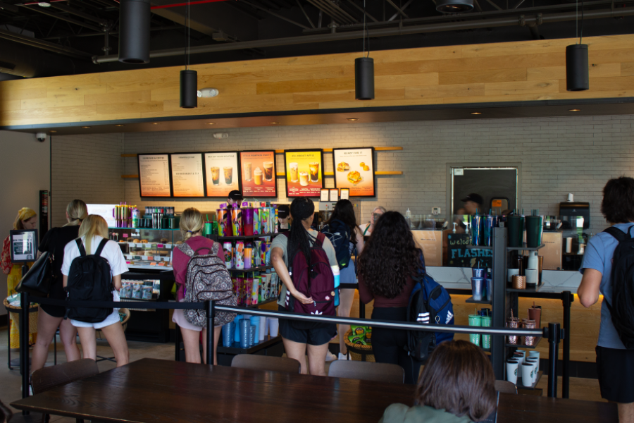 Interior view of the Starbucks Esplanade, with students in line and baristas working behind the counter