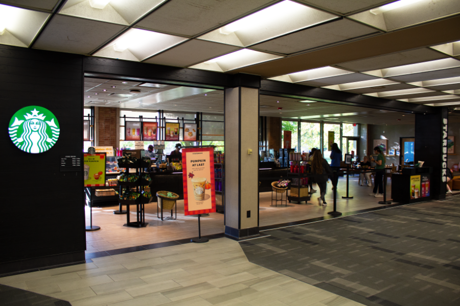 Wide shot of the Starbucks Library location, with baristas working behind the counter and students waiting in the lobby/seating area