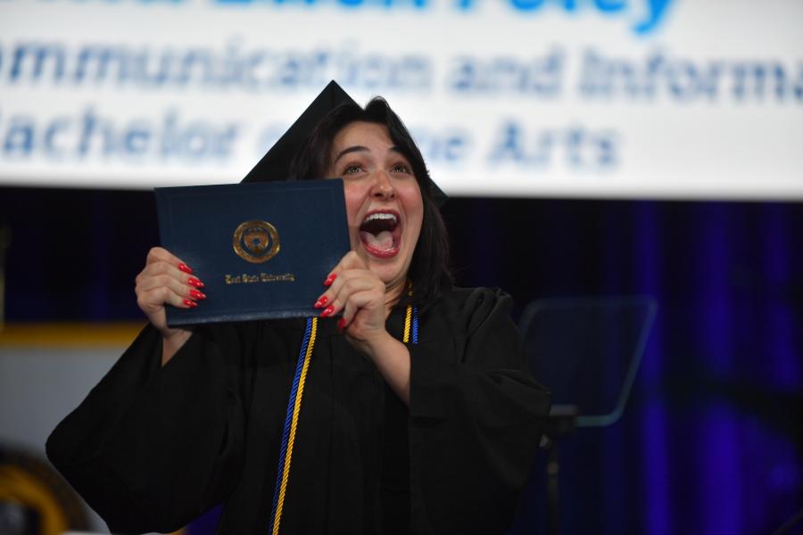 A new graduate celebrates earning a degree during 2025 Fall Commencement ceremonies