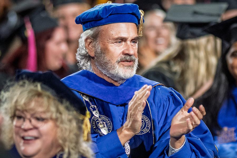 Kent State President Todd Diacon cheers on the graduating students during the university's fall 2025 commencement.