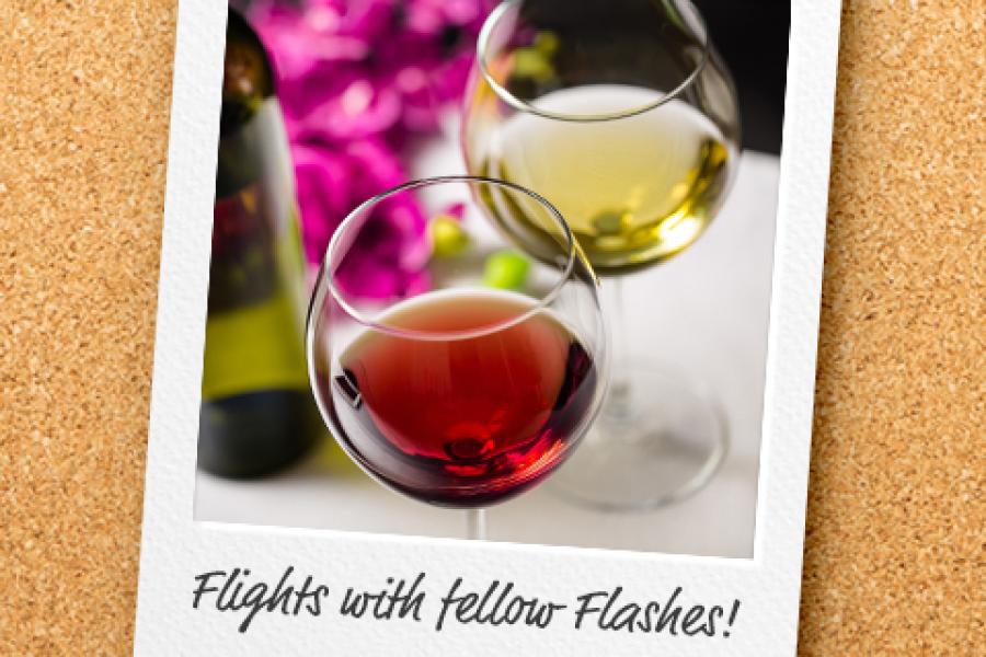 Polaroid of wine glasses filled with wine.