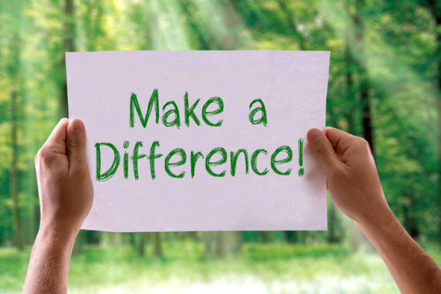 Two hands holding up a piece of paper that says "make a difference"