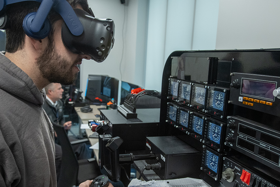 A student uses extended reality in a flight simulation