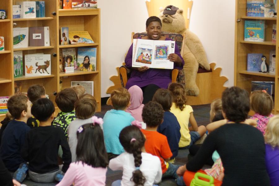 Angela Johnson, SLIS writer in residence, reads to children in the Marantz Picturebook Collection room.