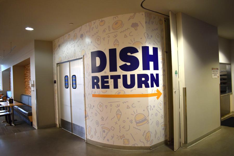 Eastway's Dish Return entrance, with the words" Dish Return" in large letters on the wall with an arrow pointing to the right