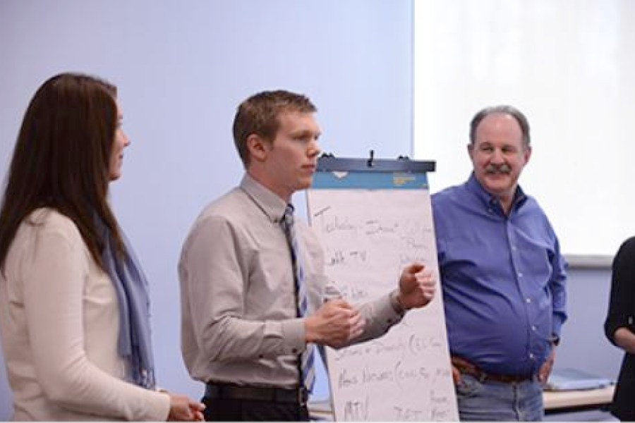Program participants present on a large pad of paper