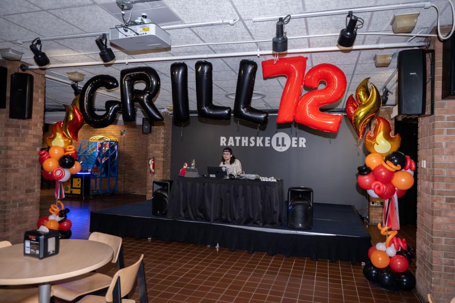 Close up view of the stage within Grill '72 with letter balloons handing above reading "Grill 72"