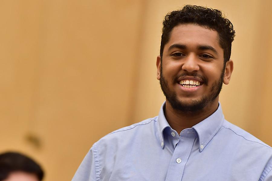 Student in classroom smiling