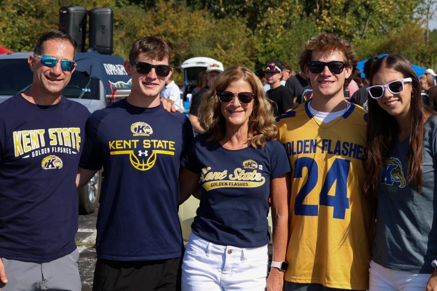 Five family members standing side by side, all smiling at the camera and wearing various Kent State shirts