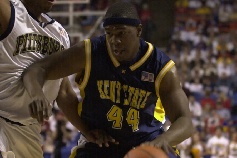 Kent State basketball player Antonio Gates wearing jersey number 44 drives to the basket against a University of Pittsburgh defender.