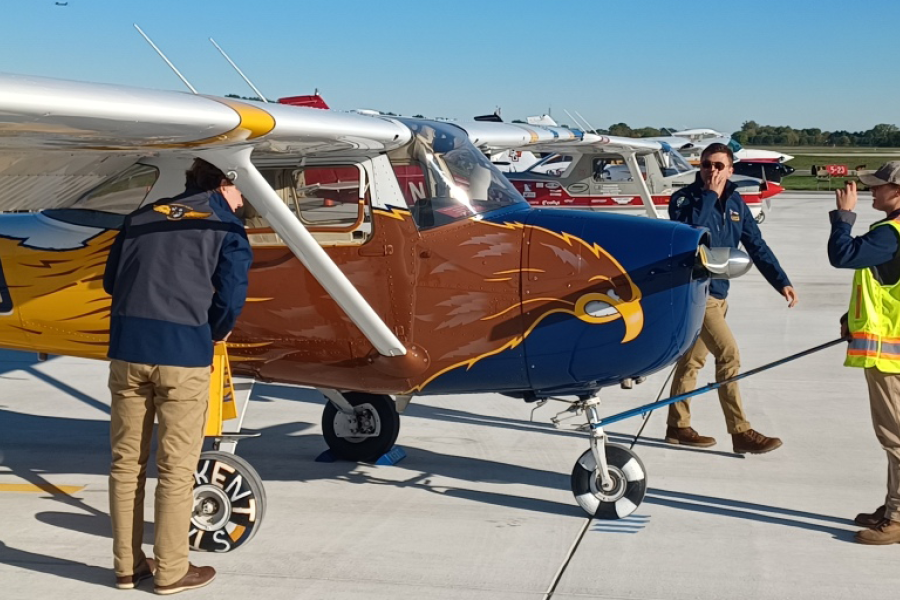 Three students prepare an airplane for inspection at the NIFA SAFECON championships
