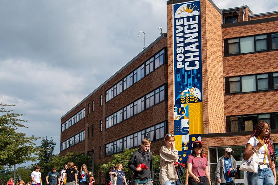 students walk past new graphics on 鶹ӰԺ State's campus