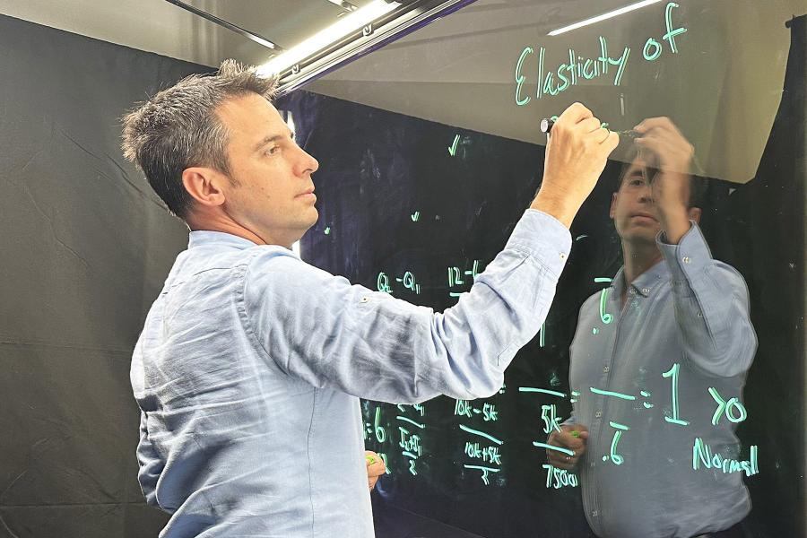 Shawn Rohlin, Ph.D., professor of economics, records a lecture for an online course in the Crawford Hall production studio.