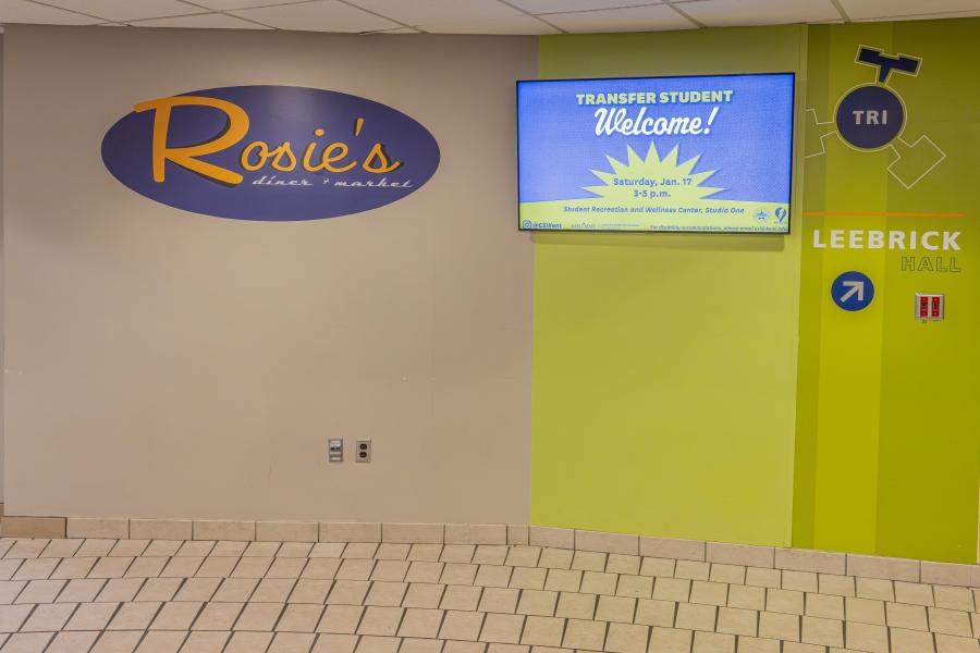 A wall within Tri Towers Rotunda with the Rosie's Diner + Market logo