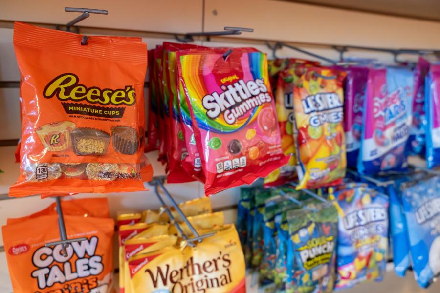 Close up of handing bags of various candy and snacks available for purchase at Rosie's Market