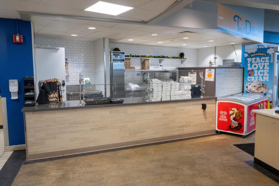 Wide view of the Tri Deli counter and prep area within Rosie's Diner