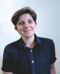 Person with dark hair and dark blue shirt
