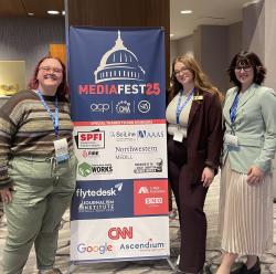 Three ����ɫ��ҹ student journalists stand smiling beside a MediaFest ’25 conference banner at the College Media Association event in Washington, D.C.