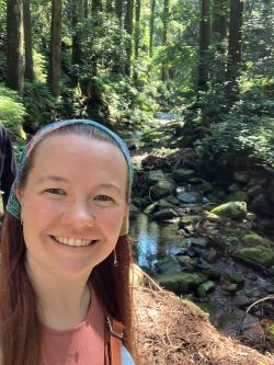 Woman standing in front of creek