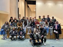 Drew stands at the front of a class group photo