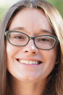 Woman with light brown hair and glasses