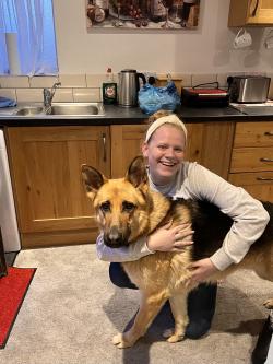 EHHS student Kari hugging her Irish host family's dog, Bear.
