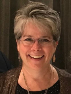 A headshot photo of Kate McDermont smiling