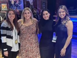 Rachell poses with coworkers at an event