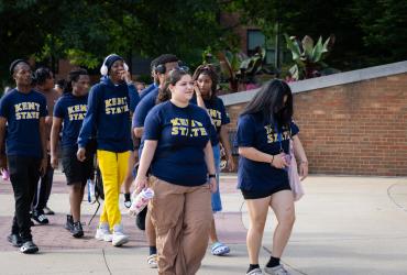 A group of upward bound students walking around Centennial Court