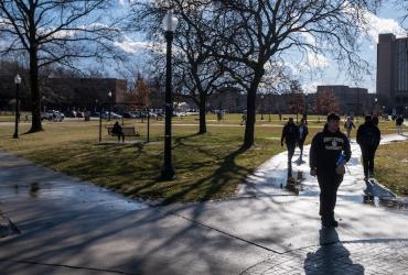 Students walk campus in January with long shadows