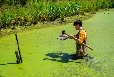 SURE student collecting sediment samples.