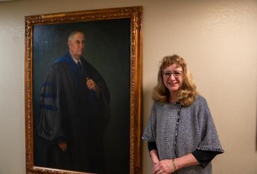 Ellen Engleman Conners, poses near the portrait of her great-grandfather, žž State's third president, James Engleman.