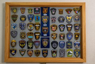Showcase of police department patches from other cities