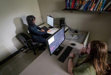 Joshua Behler (right) observes an eye-tracking participant in the lab