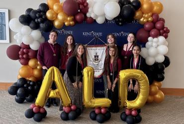 Alpha Lambda Delta officers stand for group photo with ALD shaped letter balloons.