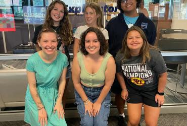 Bre posing with a group of friends in the Lake Hall lounge