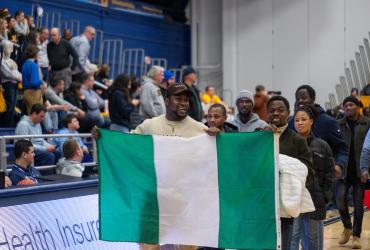 Emmanuel holding the flag of Nigeria