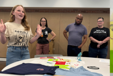 Photo of student presenting to a group of people.