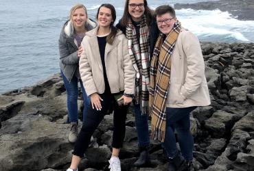 Moira at the beach with a group of students