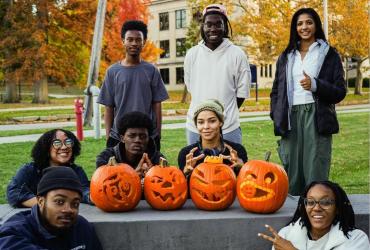 Toby and members of NOMAS pose with carved pumpkins.