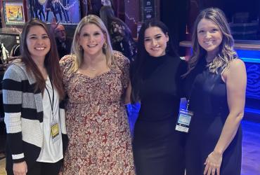 Rachell poses with coworkers at an event