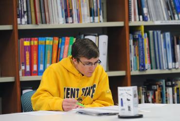 A Kent State student enjoys a peaceful space in the University Library to catch up on studying during finals week.