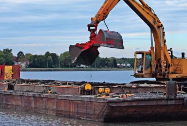 Image of excavator on a boat