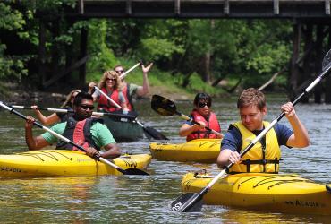 Kent State students paddle their way down the Cuyahoga River near downtown Kent. Kent State’s Department of Recreational Services runs Crooked River Adventures, offering kayak, canoe, paddleboard and tubing trips during the summer months.