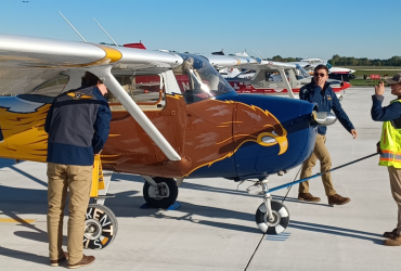Three students prepare an airplane for inspection at the NIFA SAFECON championships