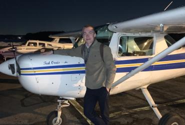 Miles posing with a KSU plane