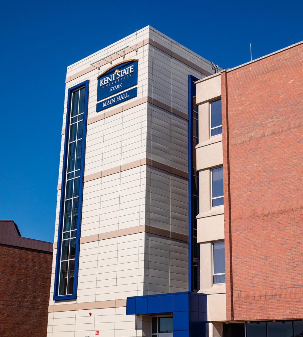 Exterior view of Kent State University at Stark's Main Hall under a clear blue sky.