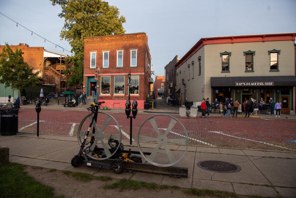Downtown Kent storefronts and outdoor dining areas along a brick street.