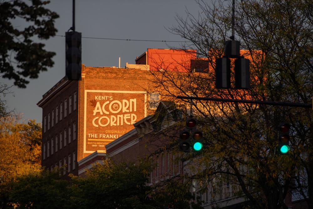 Downtown Kent buildings illuminated by evening sunlight.